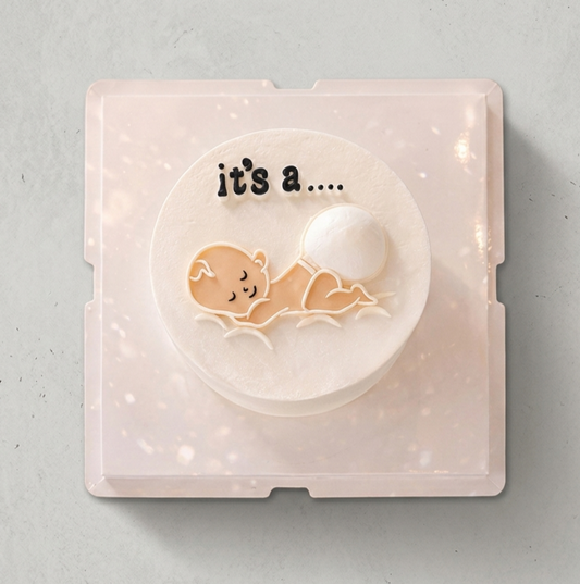 Baby gender reveal cake with a sleeping baby topper and soft cloud-like details by Good Day Bakery Singapore.