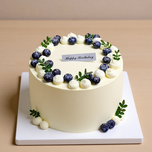 Blueberry Whisper Cake with ivory-white frosting and blueberries, ideal for birthdays.