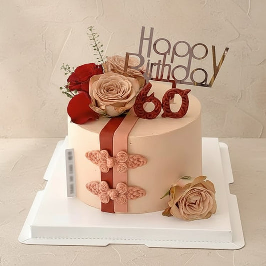 Blush rose birthday cake with elegant frosting, roses, and a stylish ribbon for celebrations.