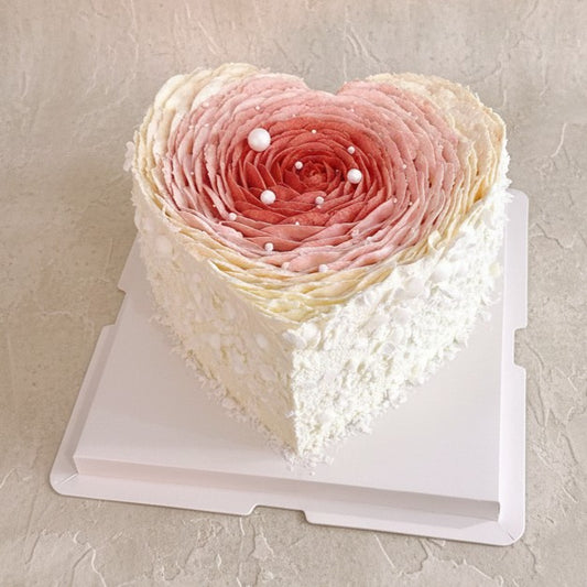 Blushing Petal Heart Cake | heart shaped cake for Mother's Day with pink petals and pearl accents.