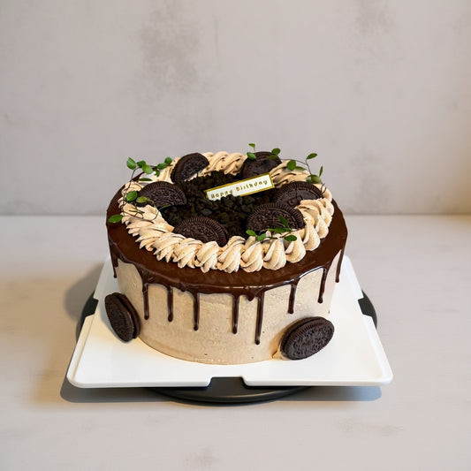 Choco Cookie Drip Cake with dark chocolate drip, cookie details, and a decorative 'Happy Birthday' sign from Good Day Bakery.