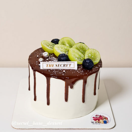 Choco Grape Secret Cake Singapore with glossy dark chocolate drip and fresh fruits on top by Good Day Bakery Singapore.