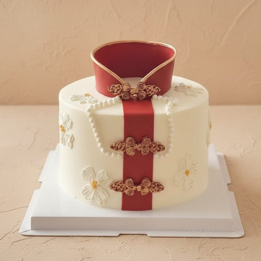 Imperial Red Ribbon Fondant Cake beautifully decorated with sugar pearls and blossoms, perfect for celebrations.
