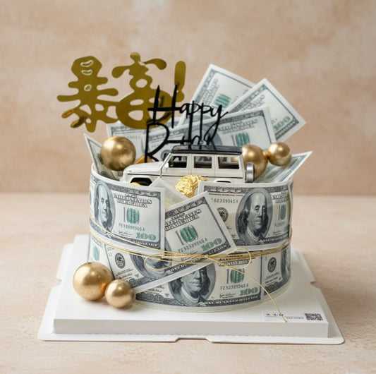Luxury fortune cake decorated with edible $100 bills, silver car topper, and golden spheres for a lavish celebration.