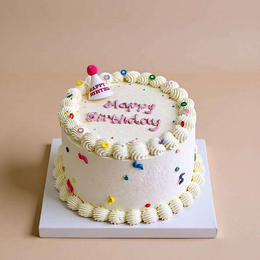 Colorful Cake Colorful confetti birthday cake with pink party hat topper