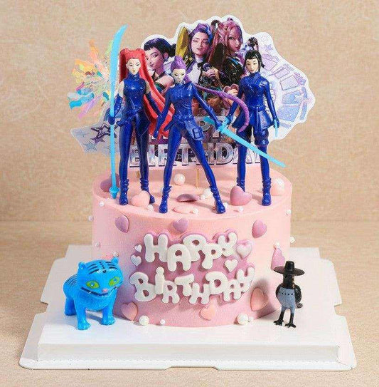 Galactic Cake with pastel pink and lavender ombre frosting topped with 3D blue warrior girl action figures and blue tiger mascot on birthday cake board