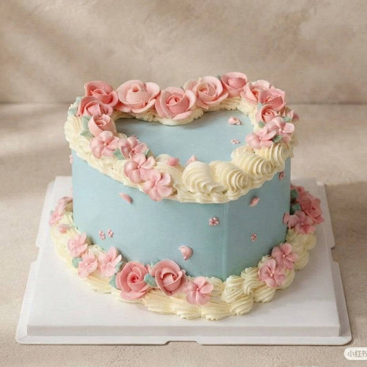 Heart cake with powder blue frosting and pink buttercream roses for birthday cake delivery Singapore