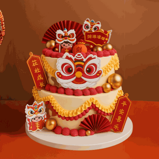 Two-tiered Lion Cake decorated with red and yellow ruffled cream swags, Chinese Lion Dance head emblem, lion figurines, gold spheres, and festive red couplets.