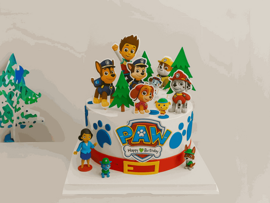Paw Patrol cake with character toppers and pine tree decorations