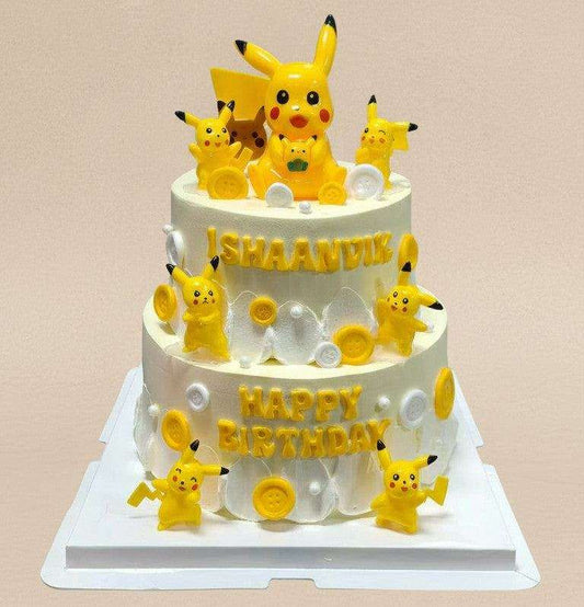 Two-tier Pikachu cake with 3D figurines and personalised yellow lettering