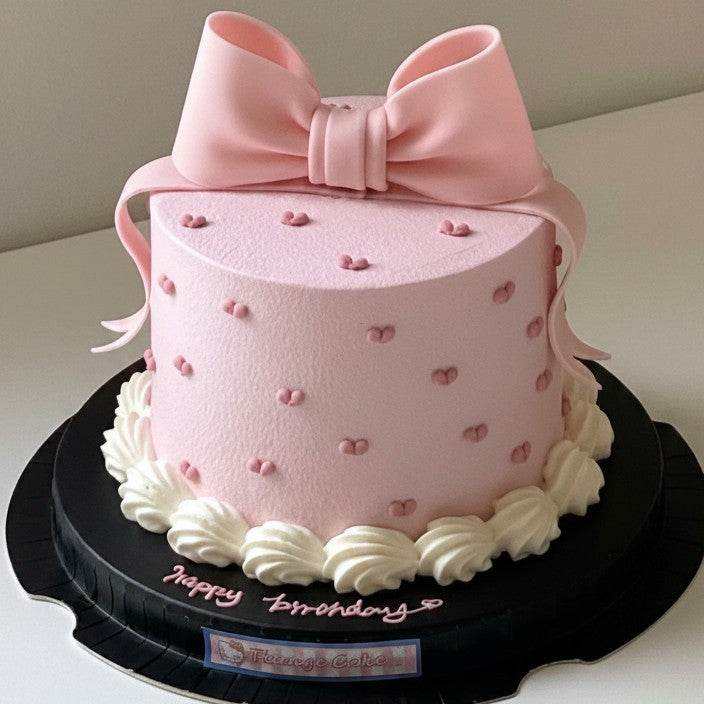 Pink bow cake with heart dots and 3D fondant ribbon