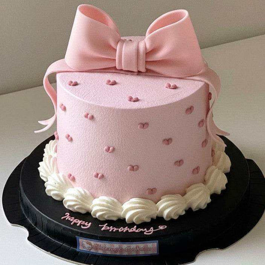 Pink bow cake with heart dots and 3D fondant ribbon