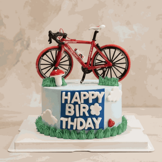 bike cycling cake with blue frosting and green grass accents