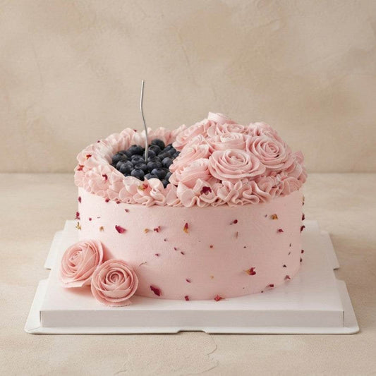 Blush pink Rose & Blueberry Cake with buttercream roses and silver candle