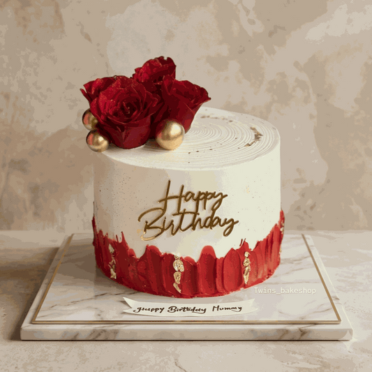 Luxurious crimson roses cake with gold leaf accents and gold topper