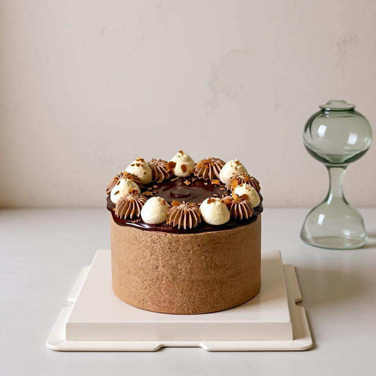 Salted caramel chocolate cake with dark ganache and cream rosettes